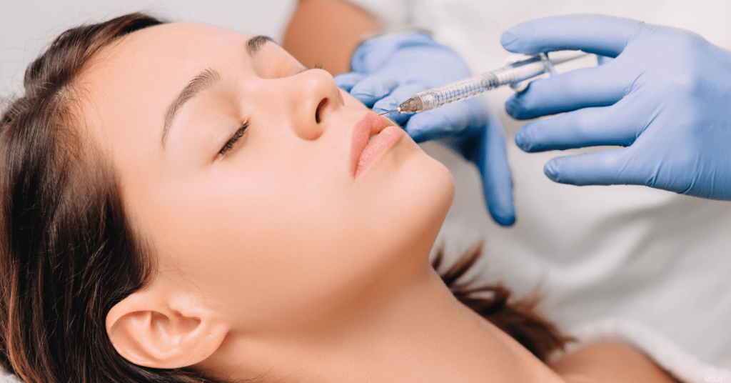 A woman receives lip injections.