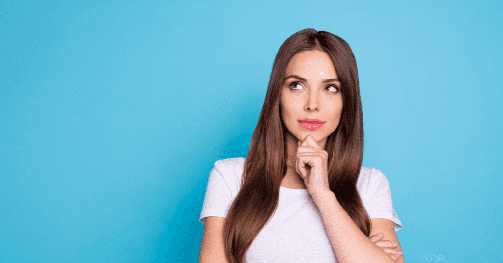 Woman in front of light blue background