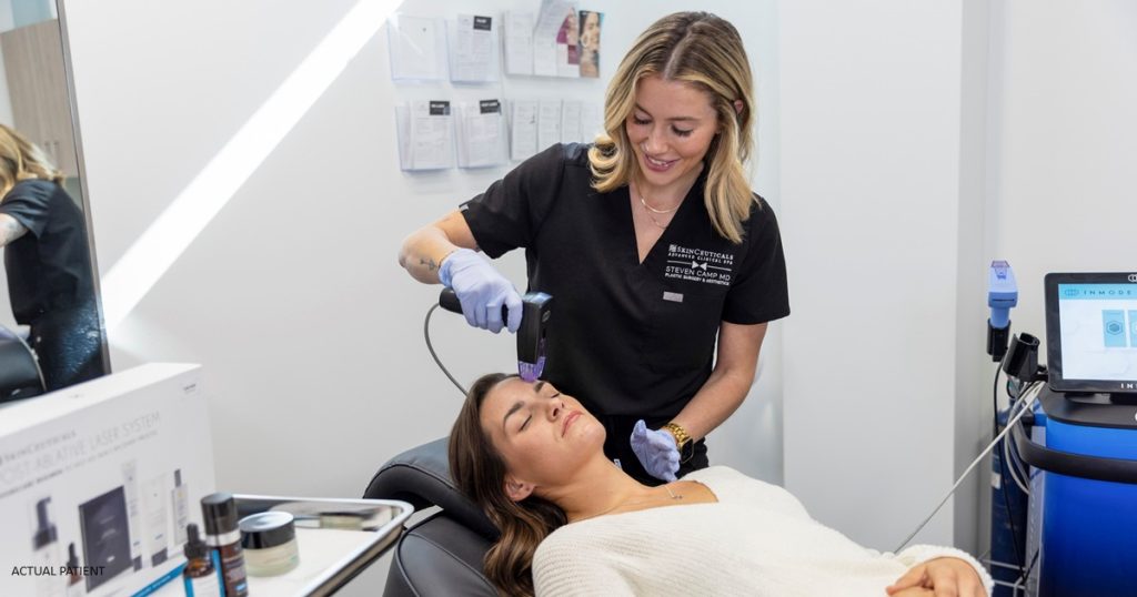 Lindsay Anderson, Aesthetician & Laser Technician performing a laser treatment
