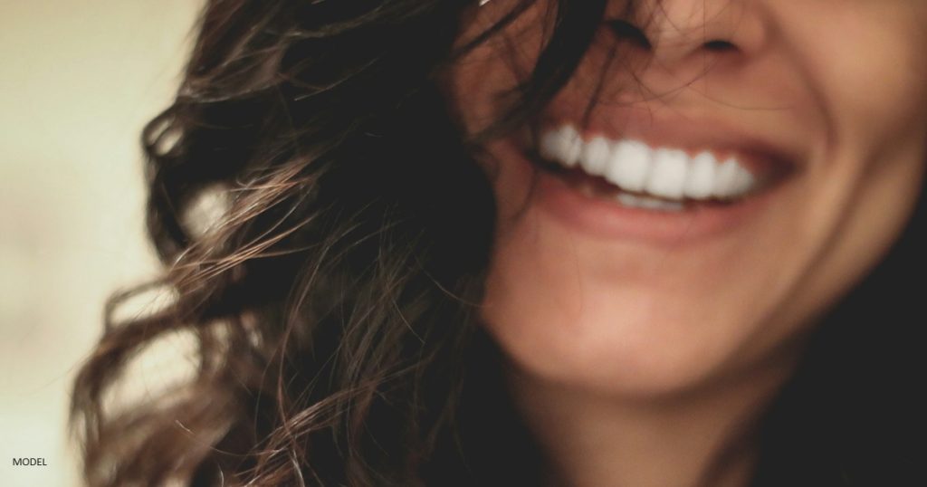 Dark haired woman smiling at camera